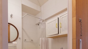 A compact bathroom with a toilet, sink, and shower. - Ocean and Sugarloaf Mountain View Prf805 (Rio de Janeiro)