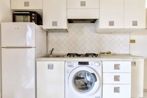 Private kitchen - Functional 28 sq m studio apartment, 150 meters from the beach.It features a fully equipped kitchenette, a sofa bed, a small bedroom with a double bed, and a bathroom with a shower.The apartment is located on the ground floor and boasts an outdoor patio  (Marinella)