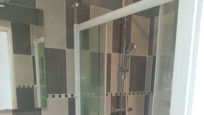 A modern bathroom with a glass-enclosed shower, a white sink with a marble countertop, and a tiled floor. - Free room/parking and bus in front (Amiens)