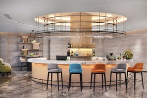A modern bar area with a circular design, bar stools, and a well-lit space. - Hampton by Hilton Ningde Lithium Electricity Town (Ningde)