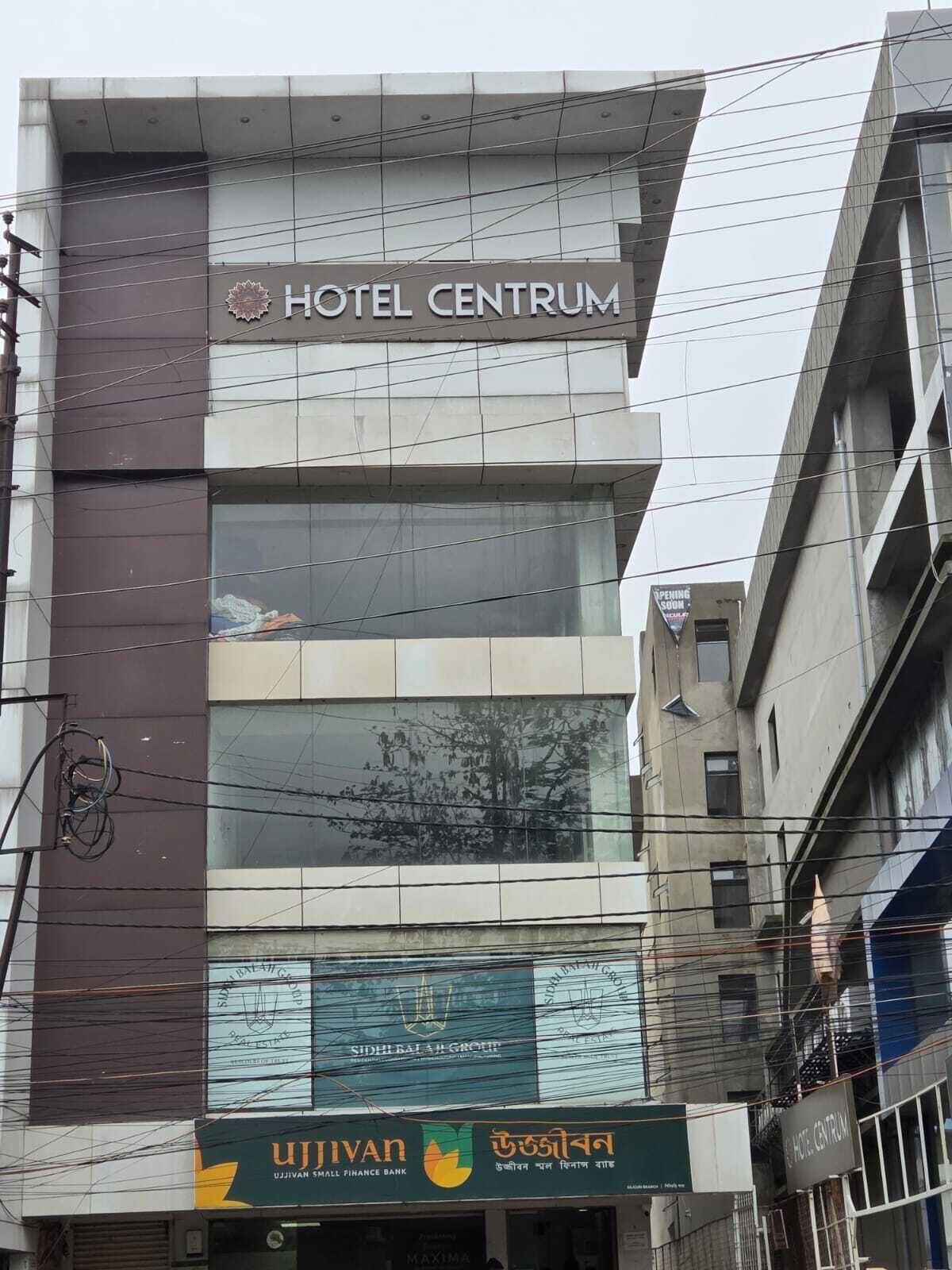 A multi-story building with a sign reading "HOTEL CENTUM".