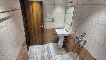 Standard Double Room | Bathroom | Shower, slippers, towels, soap