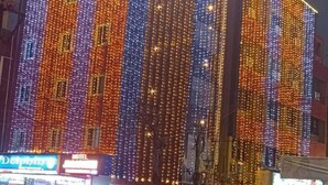 A hotel with a vertical strip of lights on its facade. - HOTEL JAGAPATHI INTERNATIONAL (Vijayawada)