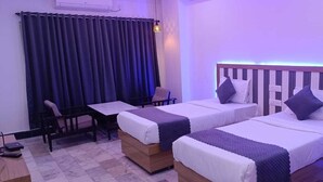 A hotel room with two single beds, a desk, and a chair. - HOTEL JAGAPATHI INTERNATIONAL (Vijayawada)