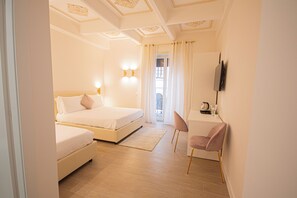 A bedroom with a bed, a desk, and a chair.