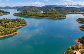 A large body of water with multiple islands, surrounded by hills.