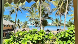 A view of a tropical resort with palm trees and a beach. - Holiday Beach Hotel (Nosy Be)