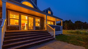 A two-story house with a porch and steps leading to the entrance. - NEW! Ocean View, Hot Tub, Game Room (Nant@Beach) (Ocean Park)