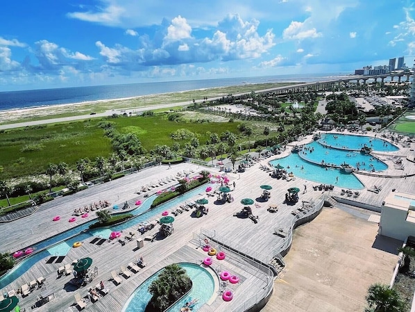 A resort with multiple swimming pools, a beach, and a view of the ocean. - Luxury Bayfront Retreat at Caribe Resort (Orange Beach)