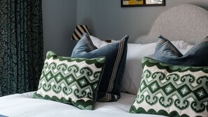 A bedroom with a bed, pillows, a lamp, a painting, and curtains. - The Great Decoy (Hurstbourne Tarrant)