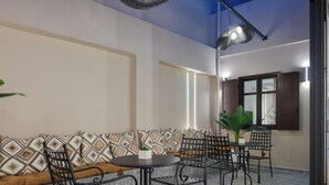A modern indoor space with a sofa, chairs, and a small table.