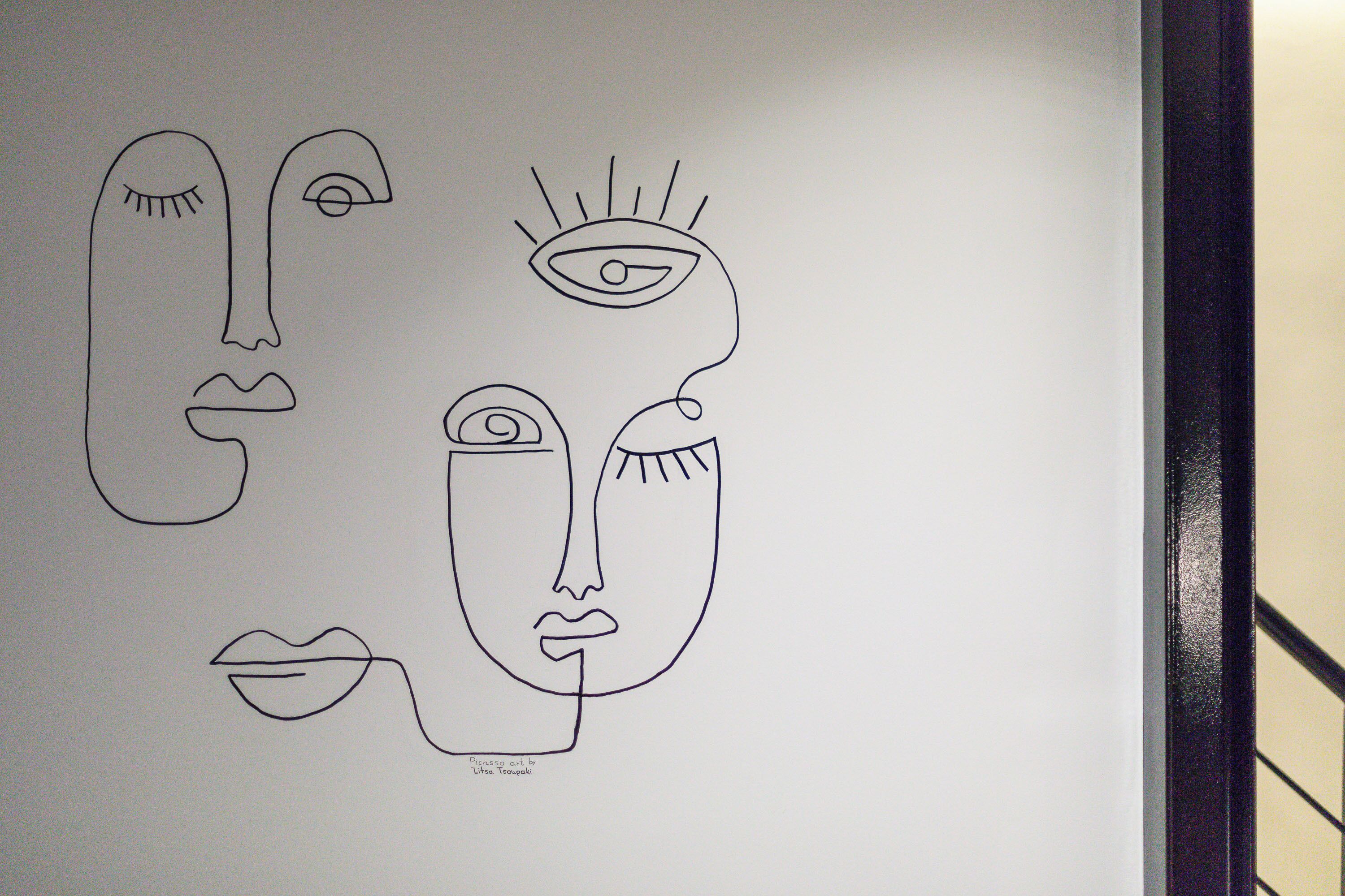 A simple line drawing of a face with a nose, eyes, and mouth.