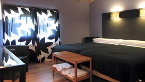 A bedroom with a bed, bedside tables, a wooden bench, and a window with patterned curtains. - Country House 'Villabamba 4' with Mountain View, Shared Terrace and Wi-Fi (Valdeavellano de Tera)
