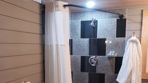 A shower area with a white shower curtain, a white towel on the wall, and a black and white striped rug on the floor. - Loft suite with cozy Queen minutes from Makers Mark , Log Still , Gethsamane (Loretto)