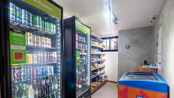 A vending machine area with various beverage options and a QR code for information.