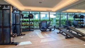 A modern gym with weightlifting equipment, cardio machines, and exercise benches. - Luxurious 2BD in Address Residences Opera Walk to Dubai Mall & Burj Khalifa (Dubai)