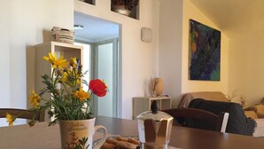A dining area with a table set for two, featuring a coffee pot and a floral mug. - Sa Domo de Mannoi, home just minutes from Sardinia's most beautiful beaches (Orosei)