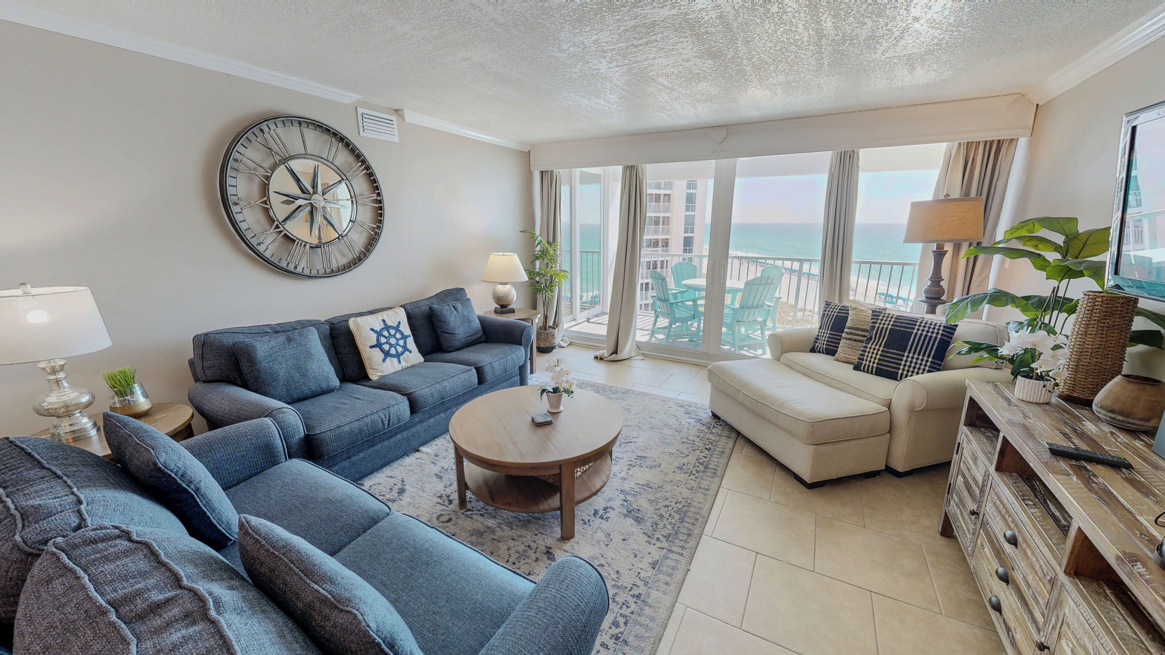 A living room with a sofa, a coffee table, and a TV.