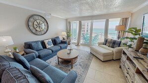 A living room with a sofa, a coffee table, and a TV. - Beach Service and Beach Views ST 2064 (Destin)