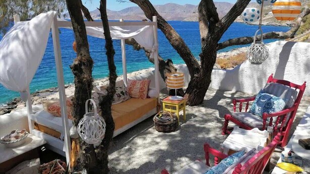 A beachside seating area with a white canopy, a sofa, and a chair. - Seafront Casa Azul Villa - Getaway in Kalymnos (Mirties)