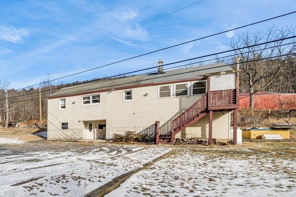A two-story house with a red staircase, a garage, and a small shed in the background. - Group Getaway w/ Fire Pit: Near Susquehanna River! (Danville)