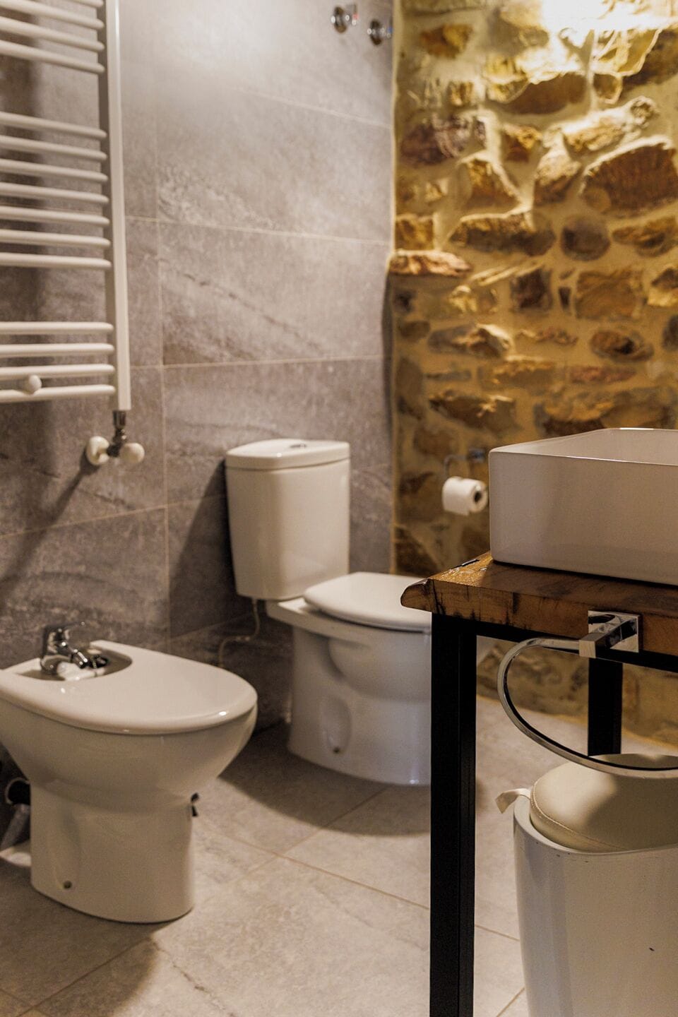 Een badkamer met toilet, hygiëneschuimer en wastafel.