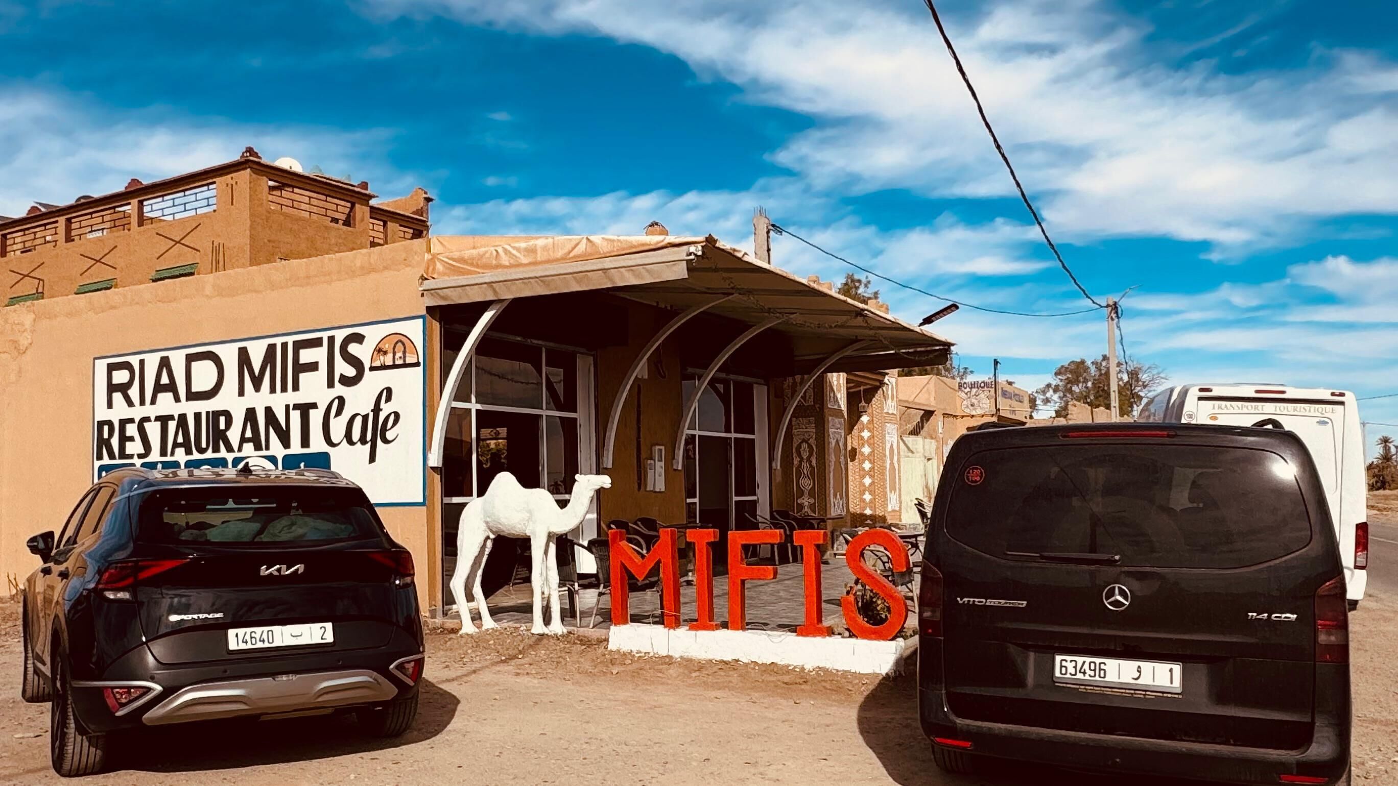A restaurant named "RIAD MIFIS" with a camel statue outside.
