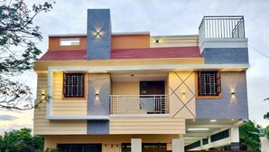 A two-story building with a balcony, a signboard, and a gated entrance. - Kumbha Nivas (Kumbakonam)