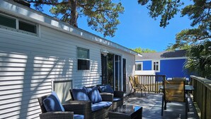 A covered deck with wicker furniture and a view of a mobile home. - 2885 Crater Lake - Sleeps 4 (Myrtle Beach)
