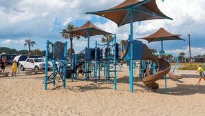 A playground with slides and climbing structures on a sandy beach. - 2885 Crater Lake - Sleeps 4 (Myrtle Beach)