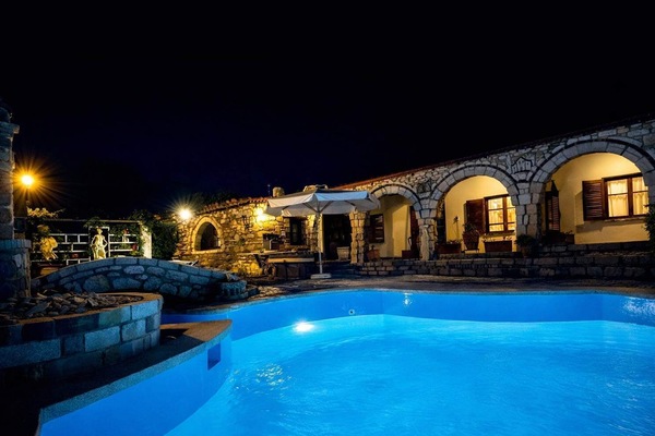 The pool area beautifully illuminated at night, creating a relaxing atmosphere for evening swims and outdoor moments.