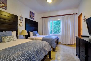 A hotel room with two beds, a window with curtains, a television on a dresser, and artwork on the walls. - ®2BR{Beach~Spot} @Terrenas+Jaccuzi+Walk~to~Beach (El Limón)