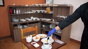 A breakfast buffet setup with various food items and utensils. - san blas plaza hotel (Cusco)