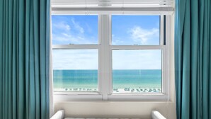 A room with a large window overlooking a beach. - Gorgeous “Dolphin Delight” 616, Penthouse, Free Activities Included! (Fort Walton Beach)