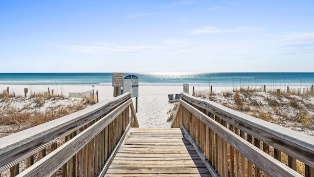 A wooden boardwalk leading to a beach with a clear sky. - Beachfront~Beach Service~Stunning Views~Free Activities~Surf Dweller 210 (Fort Walton Beach)