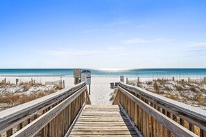 A wooden boardwalk leading to a beach with a clear sky. - Beachfront~Beach Service~Stunning Views~Free Activities~Surf Dweller 210 (Fort Walton Beach)