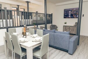 Deluxe Apartment | Living area | 60-inch Smart TV with satellite channels