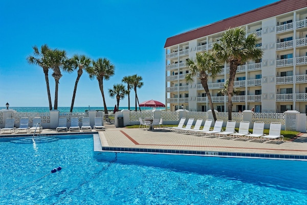 Relax by the pool with stunning views of the palm trees and beach