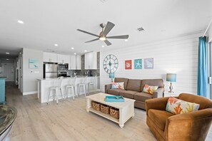 A modern kitchen with white cabinets and a stainless steel refrigerator. - Gulf Front! Pool Access! Beach Service! Veranda 102-Coastal Wave Retreat (Fort Walton Beach)