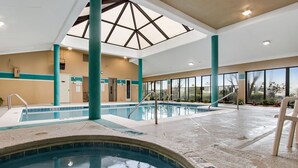 An indoor swimming pool with clear water, a skylight, and a view of the outdoors. - 🐠🌞Beachfront w/ Corner Balcony | Indoor + Outdoor Pools | Romar Place 506🌞🐠 (Orange Beach)