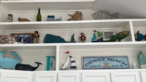 A kitchen with white cabinets and shelves displaying various decorative items. - Fun 3BR House in Rehoboth/Dewey Beach area (Rehoboth Beach)