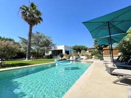 Seasonal outdoor pool, open 9:00 AM to 8:00 PM, pool umbrellas