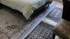 A bedroom with a large bed, a nightstand, a dresser, and a window with curtains. - Adrien's place! (Châlette-sur-Loing)