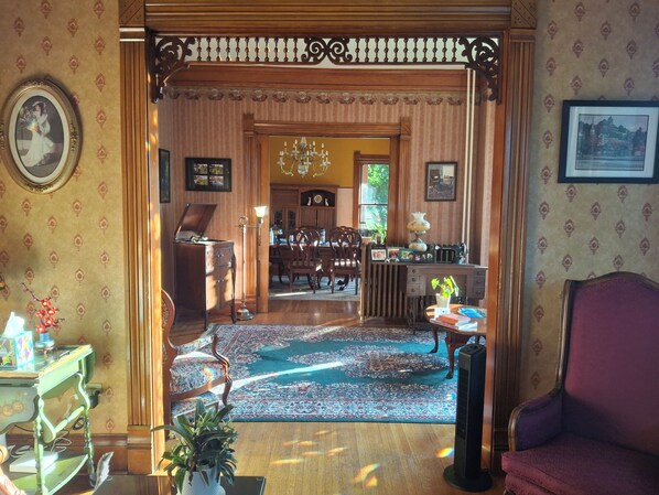 A traditional room with a wooden desk, a chair, a radiator, and a bookshelf.