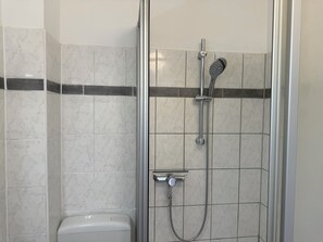 Shower, hair dryer, towels, toilet paper