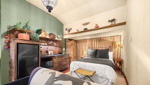 A compact hotel room with a bed, a small desk, a refrigerator, and a sofa. - Estrella De Oro Residences: Casita- Walk to town! (Golden)