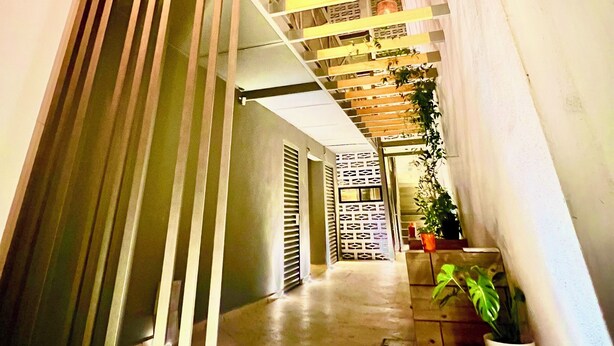 A modern interior with a sloped ceiling, vertical blinds, and hanging pendant lights. - DOUBLE SUITE - S4 (Heroica Puebla de Zaragoza)