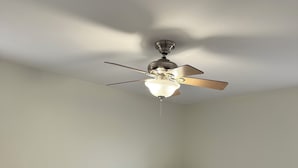 A bedroom with a bed, two bedside tables, a ceiling fan, and a window. - Manning Way (Elon)