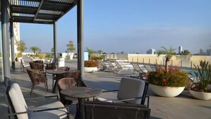A rooftop terrace with outdoor seating, a pool, and city views. - Charming apartment, incredible view (Zapopan)