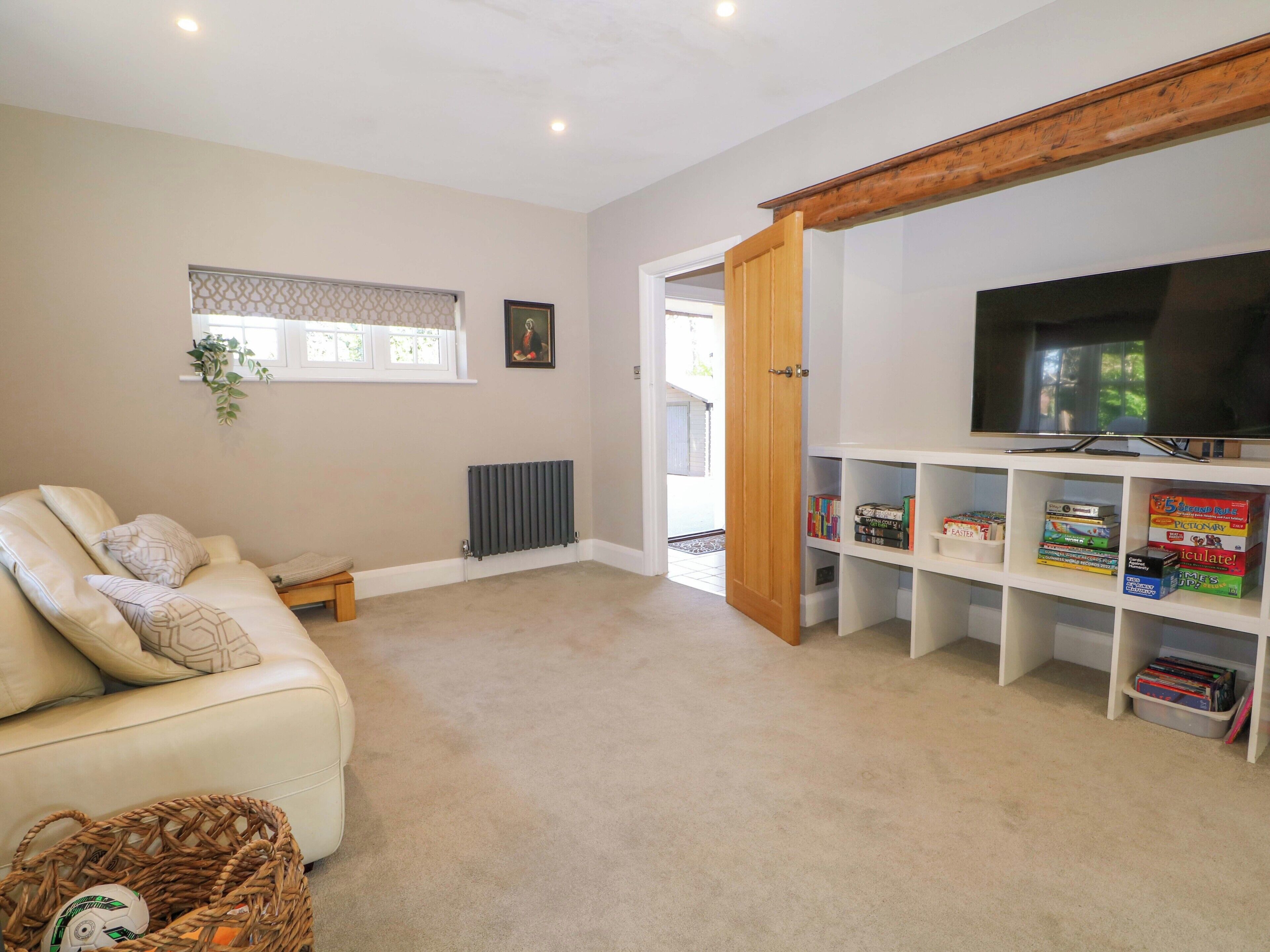 A living room with a sofa, a television, and a bookshelf.